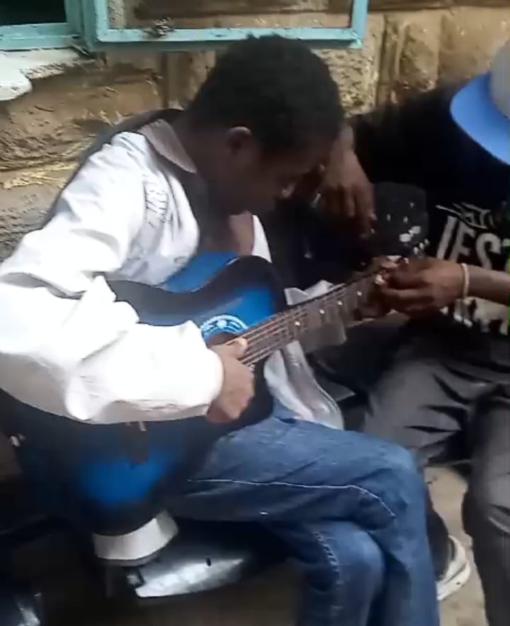 A young musician learning to play the guitar during a G4G session