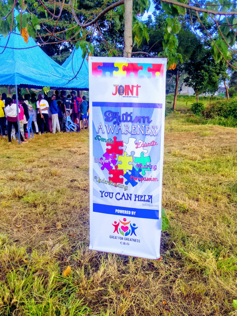 Autism awareness banner at a Great For Greatness community event